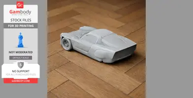Gray 3D-printed model of a vintage race car, resembling the Alpine A220, on a wooden floor.