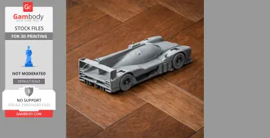 Gray 3D-printed model of a sleek, aerodynamic race car on a wooden surface.