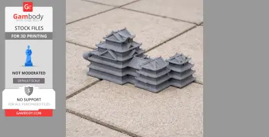 Gray 3D-printed model of Azuchi Castle on tiled surface, showcasing layered roofs and detailed architecture.