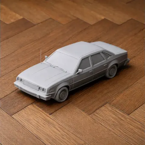 3D printed model of a classic AMC Concord car on a wooden surface.