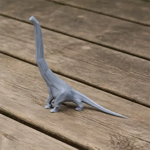 Gray 3D-printed model of a Paluxysaurus dinosaur with a long neck, standing on a wooden surface.