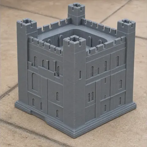 3D-printed model of a medieval castle with four corner towers and crenelated walls.