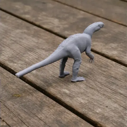 3D-printed Pantydraco dinosaur model on a wooden surface.