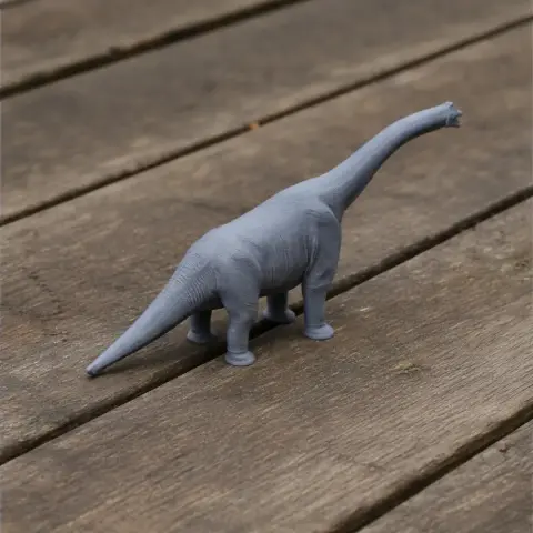 A 3D-printed grey Paralititan dinosaur model on a wooden surface.