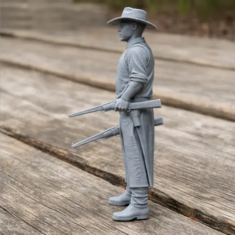Cowboy figure in a long coat and hat, holding two rifles, standing on wooden boards.
