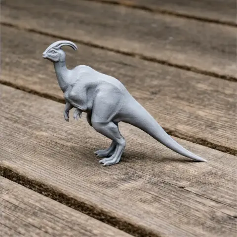 Gray 3D-printed Parasaurolophus model standing on a wooden surface.
