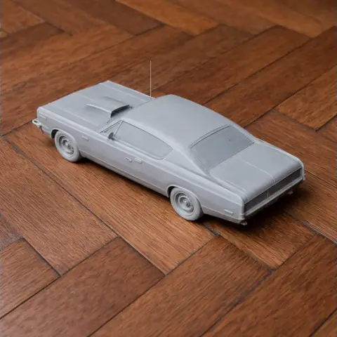 3D-printed scale model of an AMC Rebel car, viewed from the rear on a wooden surface.