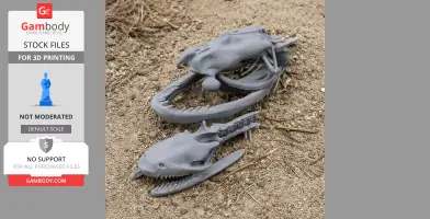 3D-printed cottonmouth skull replicas with detailed jaws, displayed on gravel.