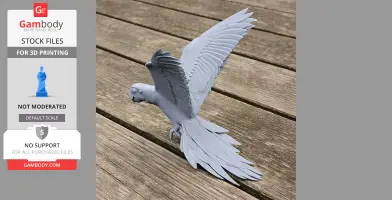 Gray 3D-printed parrot model with detailed wings, perched on a wooden surface.