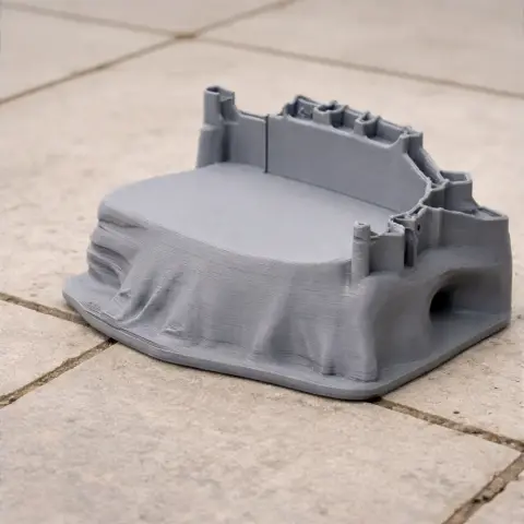 3D printed model of Berwick Castle in gray, detailed with towers and walls on a stone surface.
