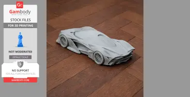 3D printed model of a sleek, futuristic sports car on a wooden floor.