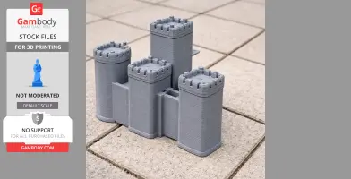 3D printed model of a castle with four cylindrical towers on a tiled surface.