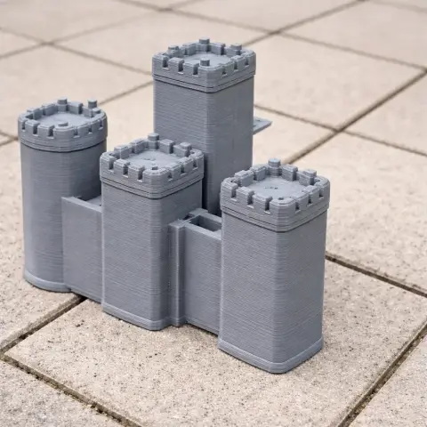 3D-printed model of Biggleswade Castle with four round towers on a tiled surface.