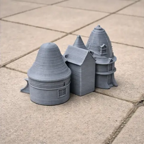 Gray 3D-printed model of Bishopton Castle with conical towers on tiled surface.