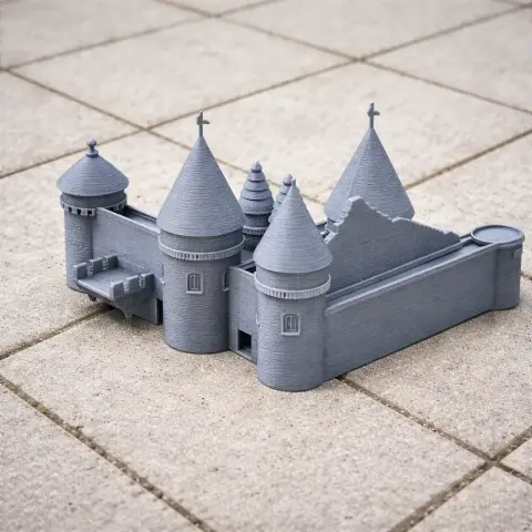 Gray 3D-printed model of a castle with multiple towers, detailed walls, and conical roofs.
