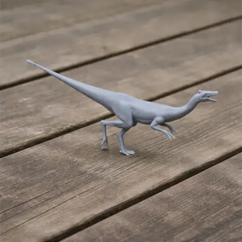 Gray 3D-printed model of Pelecanimimus, a prehistoric dinosaur, posed on a wooden surface.