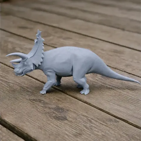 3D printed Pentaceratops model on wooden surface.