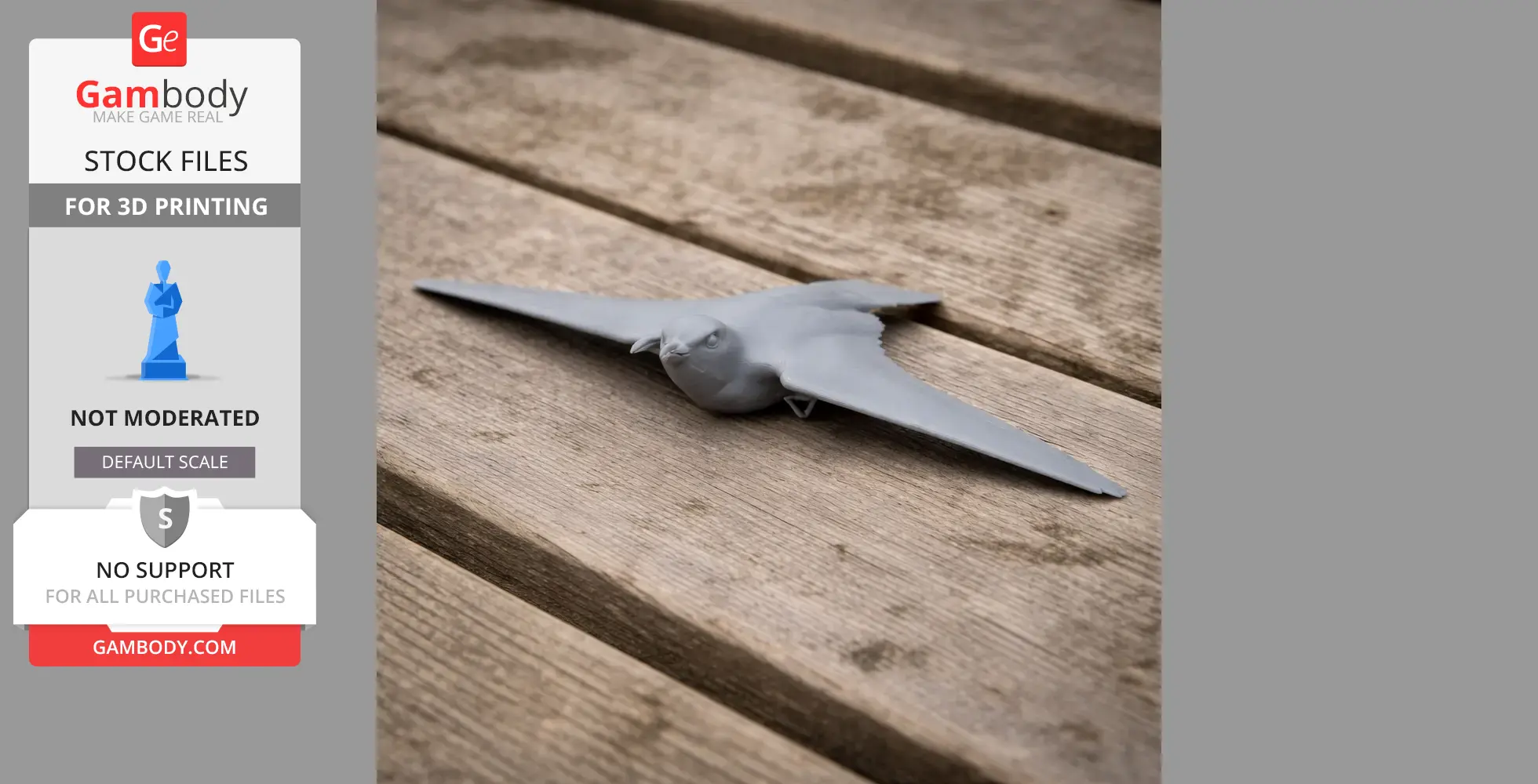 Gray 3D-printed model of a prehistoric bird, wings outstretched, lying on a wooden surface.