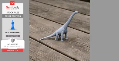 A 3D-printed gray model of a long-necked dinosaur on a wooden surface.