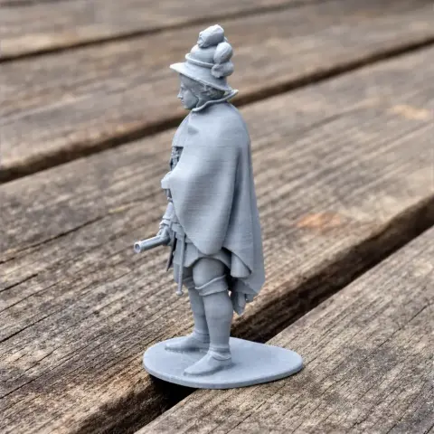 3D-printed model of a Napoleonic soldier with detailed attire and hat, standing on a wooden surface.
