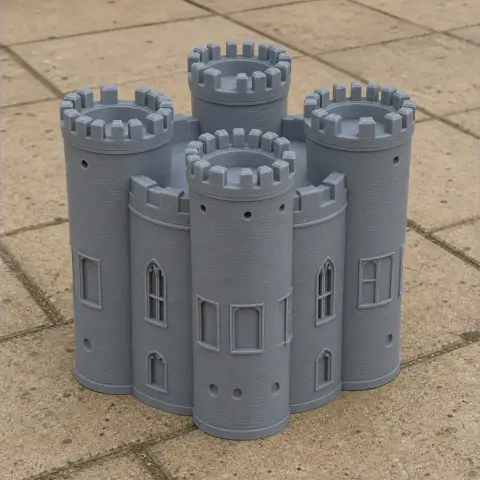 Gray 3D-printed model of a medieval castle with cylindrical towers and crenelated tops.