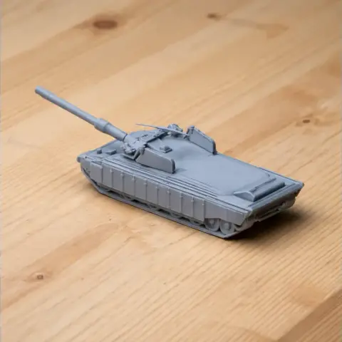 A detailed 3D-printed model of a Challenger 3 tank on a wooden surface.