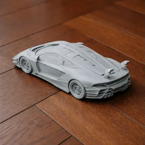 A detailed 3D printed model of a sleek sports car on a wooden surface.