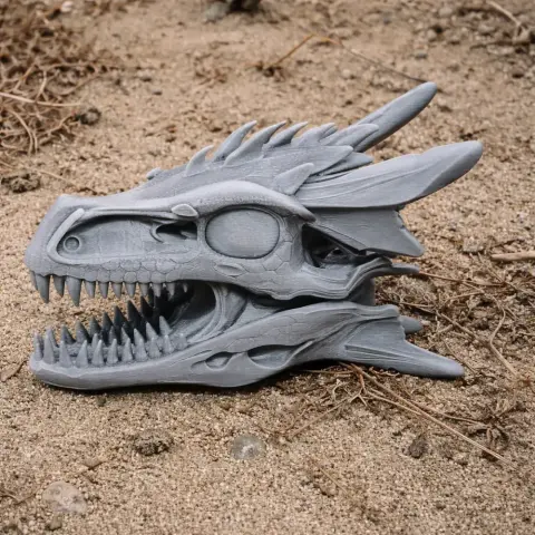 3D-printed Dracopelta skull replica with detailed textures, resting on sandy ground.