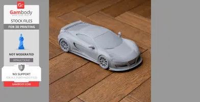 A 3D-printed scale model of a sleek sports car on a wooden surface.