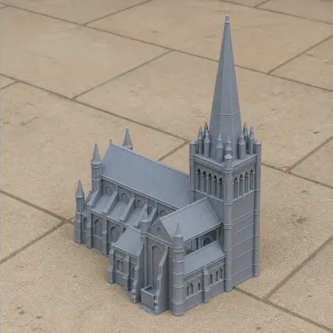Miniature 3D model of a detailed Gothic cathedral with a tall spire.