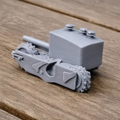 Miniature 3D-printed Churchill Gun Carrier tank model with detailed treads and turret on wooden surface.