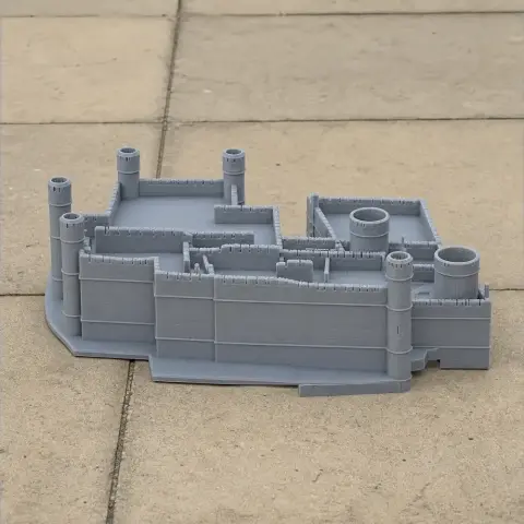 Gray 3D-printed model of Chichester Castle with towers and walls on a tiled surface.