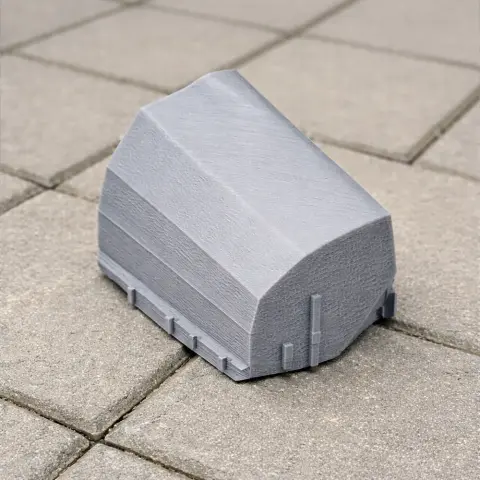 Futuristic gray building model with angular design on a tiled surface for 3D printing.