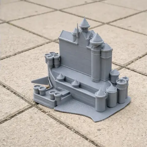 Detailed 3D-printed architectural model with towers and walls, resembling a castle structure.
