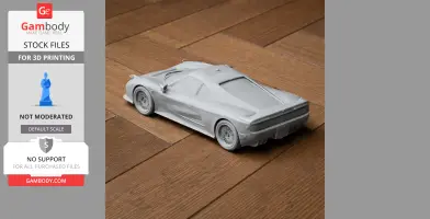 3D printed scale model of a sports car on a wooden surface.