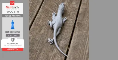 3D printed model of a Santanaraptor, a prehistoric dinosaur, lying on a wooden surface.