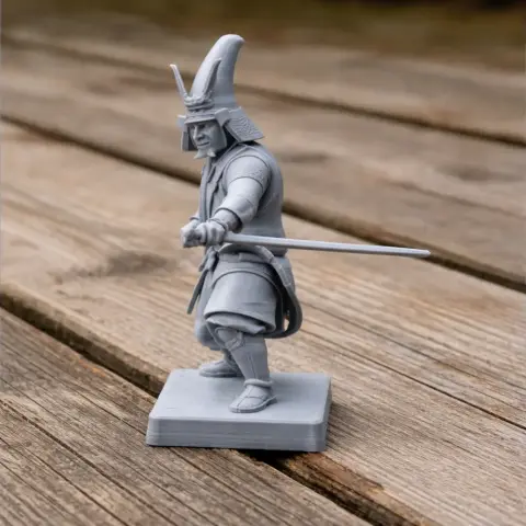 3D printed samurai figurine with armor and sword, standing on a rectangular base.
