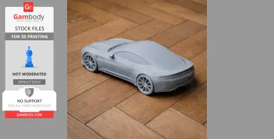 A 3D-printed model of an Aston Martin DB10 on a wooden floor.