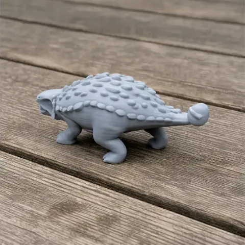 A 3D-printed Scolosaurus model with textured armor and sturdy legs, positioned on a wooden surface.