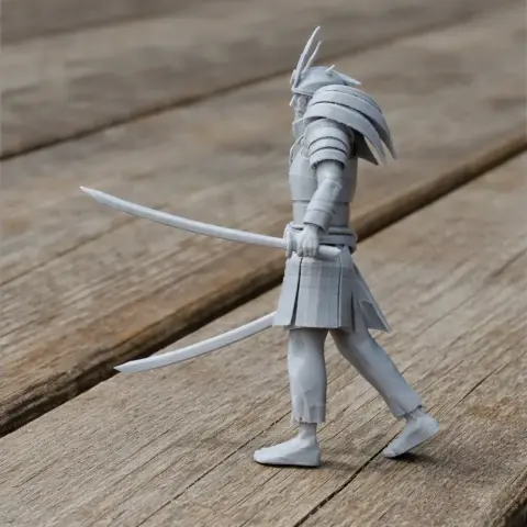 Samurai figurine with dual swords and ornate armor, standing on a wooden surface.
