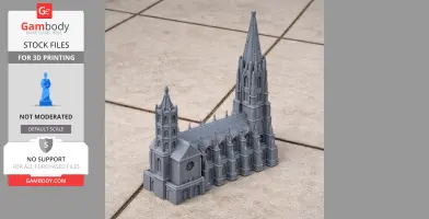 A 3D-printed model of Freiburg Minster with detailed Gothic architecture on a tiled surface.