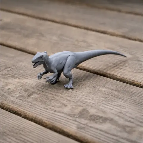 Gray 3D-printed model of a Sinovenator dinosaur on a wooden surface.