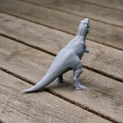 A gray 3D-printed Skorpiovenator dinosaur model stands on a wooden surface.
