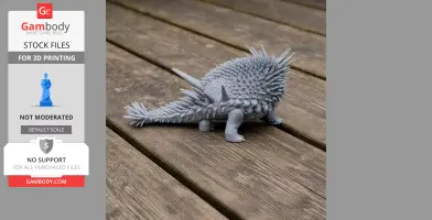 Gray, spiky 3D-printed model of Spicomellus, a prehistoric armored animal, on wooden planks.