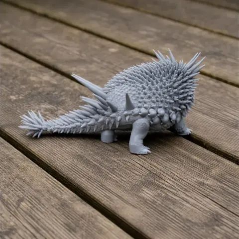 Spiky, armored prehistoric creature model with four legs, captured on a wooden surface, ready for 3D printing.