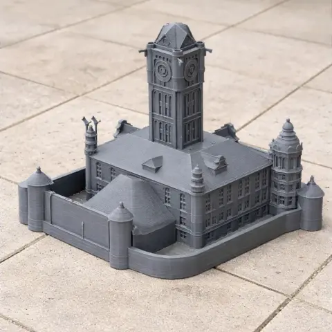3D-printed model of a Gothic-style building with a central clock tower and corner turrets.