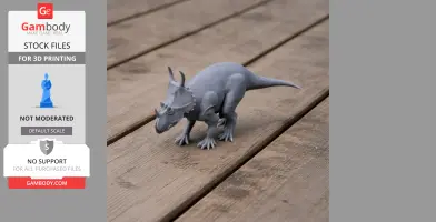 Gray 3D printed model of a horned dinosaur, Spinops, on a wooden surface.