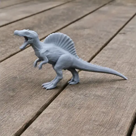 Gray 3D printed Spinosaurus model standing on a wooden surface.