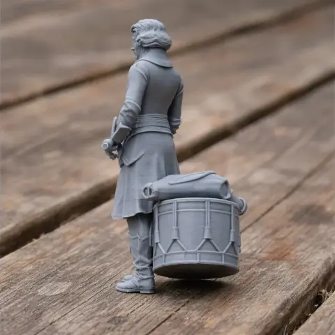 A Napoleonic soldier figurine with a drum, standing on a wooden surface.