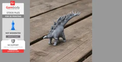 3D printed Stegosaurus model with plates and spikes, displayed on a wooden surface.